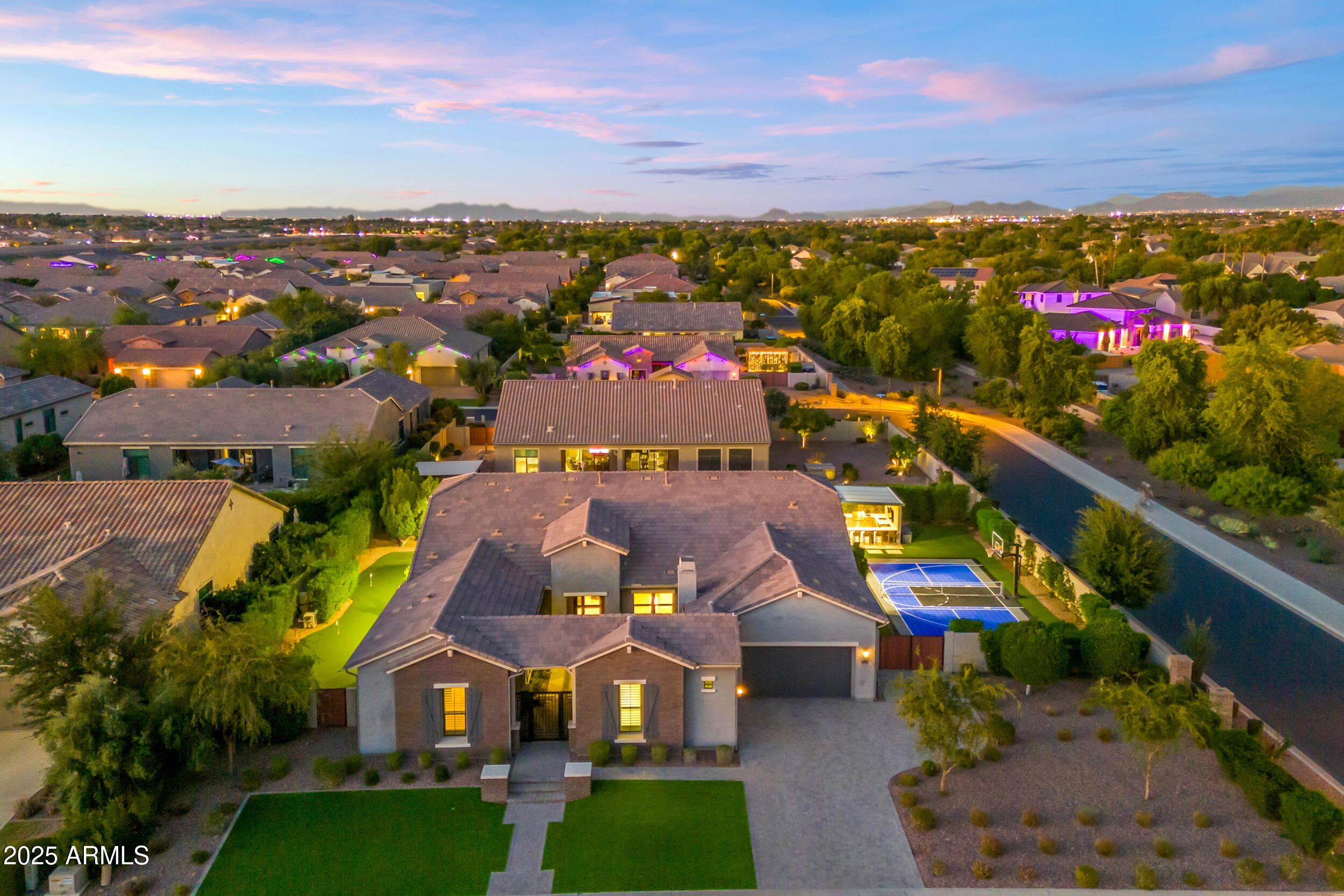 an aerial view of residential houses with outdoor space and ocean view