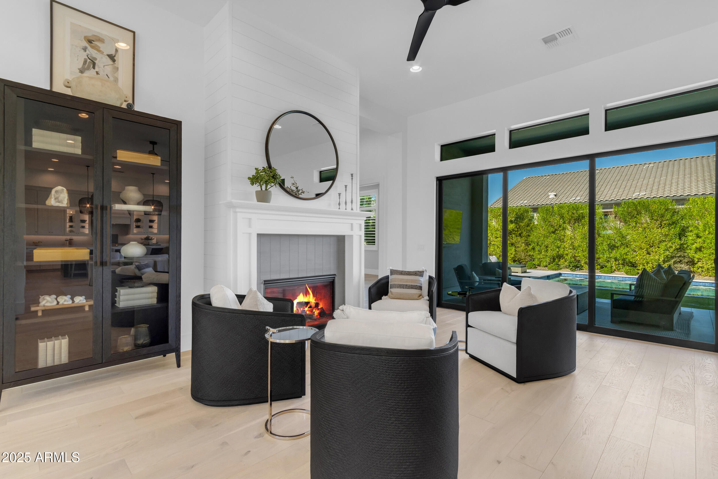 2580 East Country Shadows Street Gilbert, AZ 85298 - Photo 20 of 94 a living room with furniture a fireplace and a floor to ceiling window