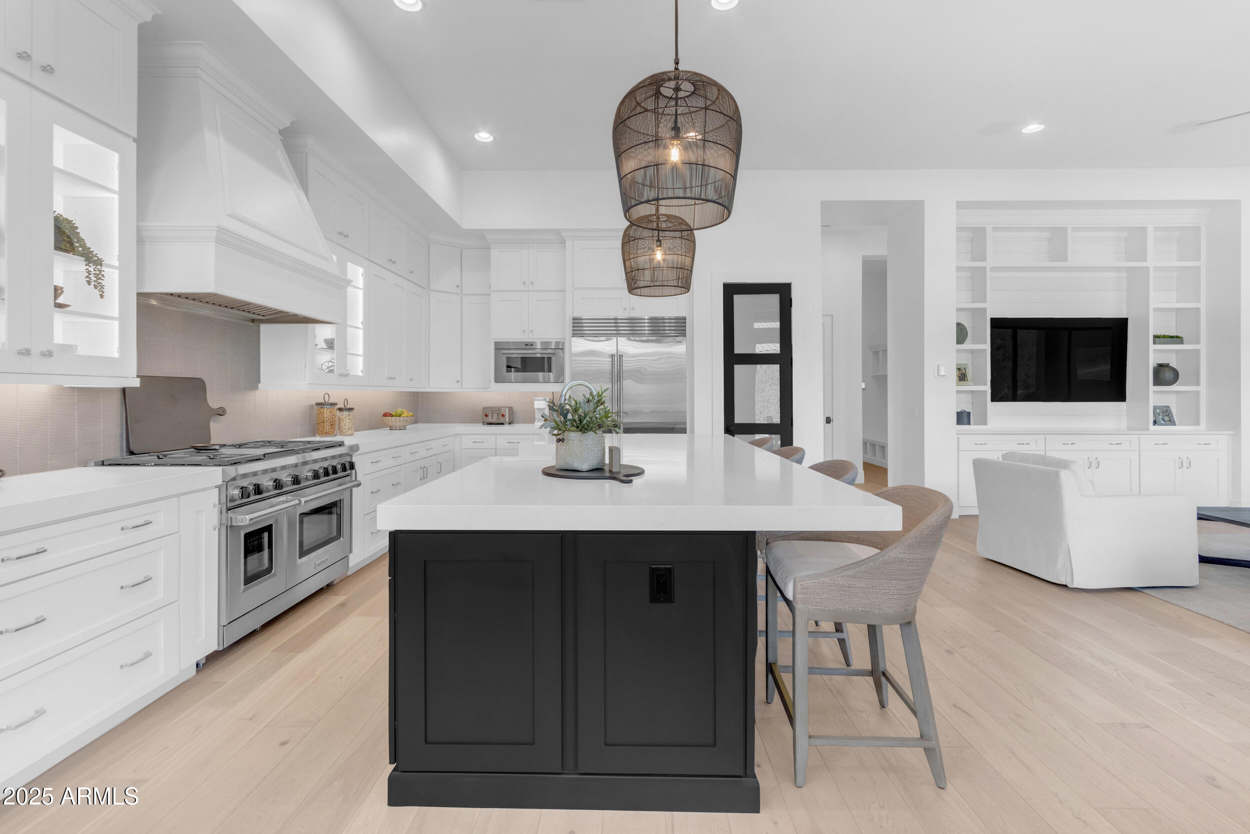 2580 East Country Shadows Street Gilbert, AZ 85298 - Photo 22 of 94 a kitchen with stainless steel appliances a dining table a stove a microwave a refrigerator and cabinets