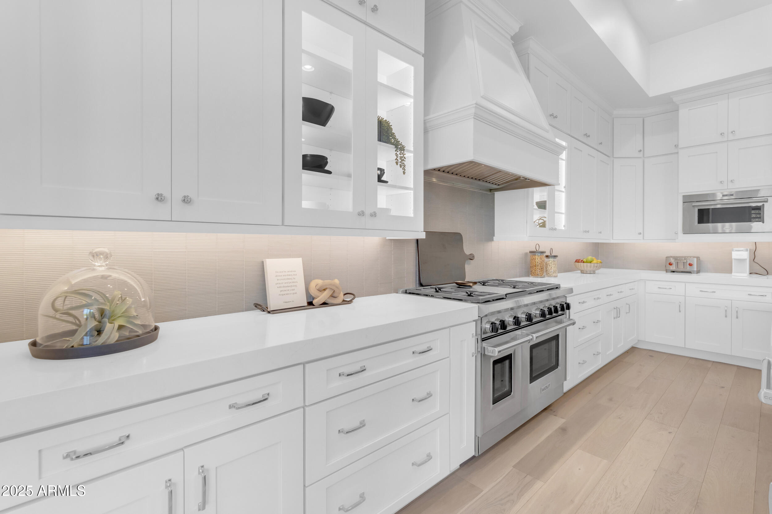 2580 East Country Shadows Street Gilbert, AZ 85298 - Photo 25 of 94 a kitchen with white cabinets and a stove