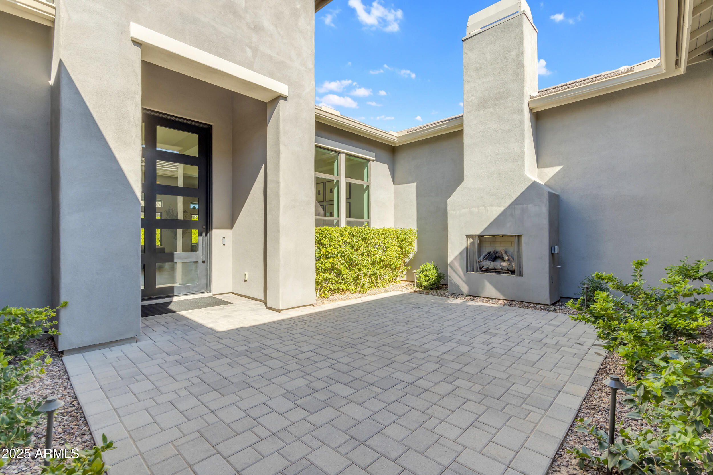 2580 East Country Shadows Street Gilbert, AZ 85298 - Photo 5 of 94 a view of a house with a yard and potted plants