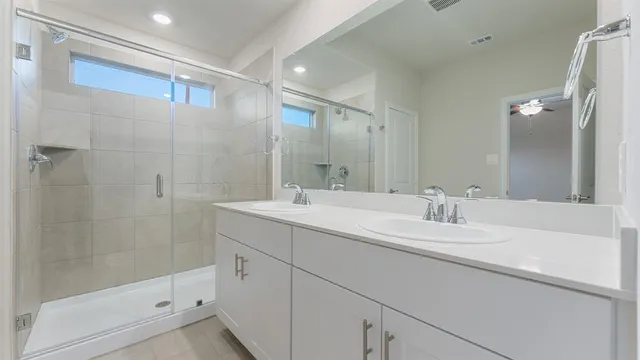 a bathroom with a double vanity sink and mirror
