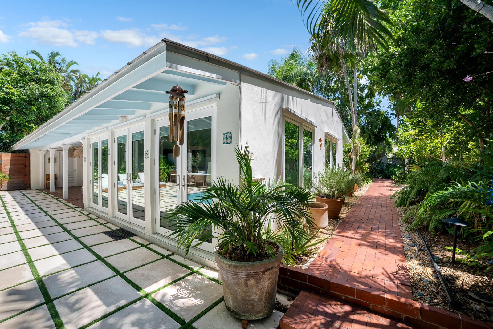 1322 George Street Key West, FL 33040 - Photo 12 of 52 a house with potted plants in front of it