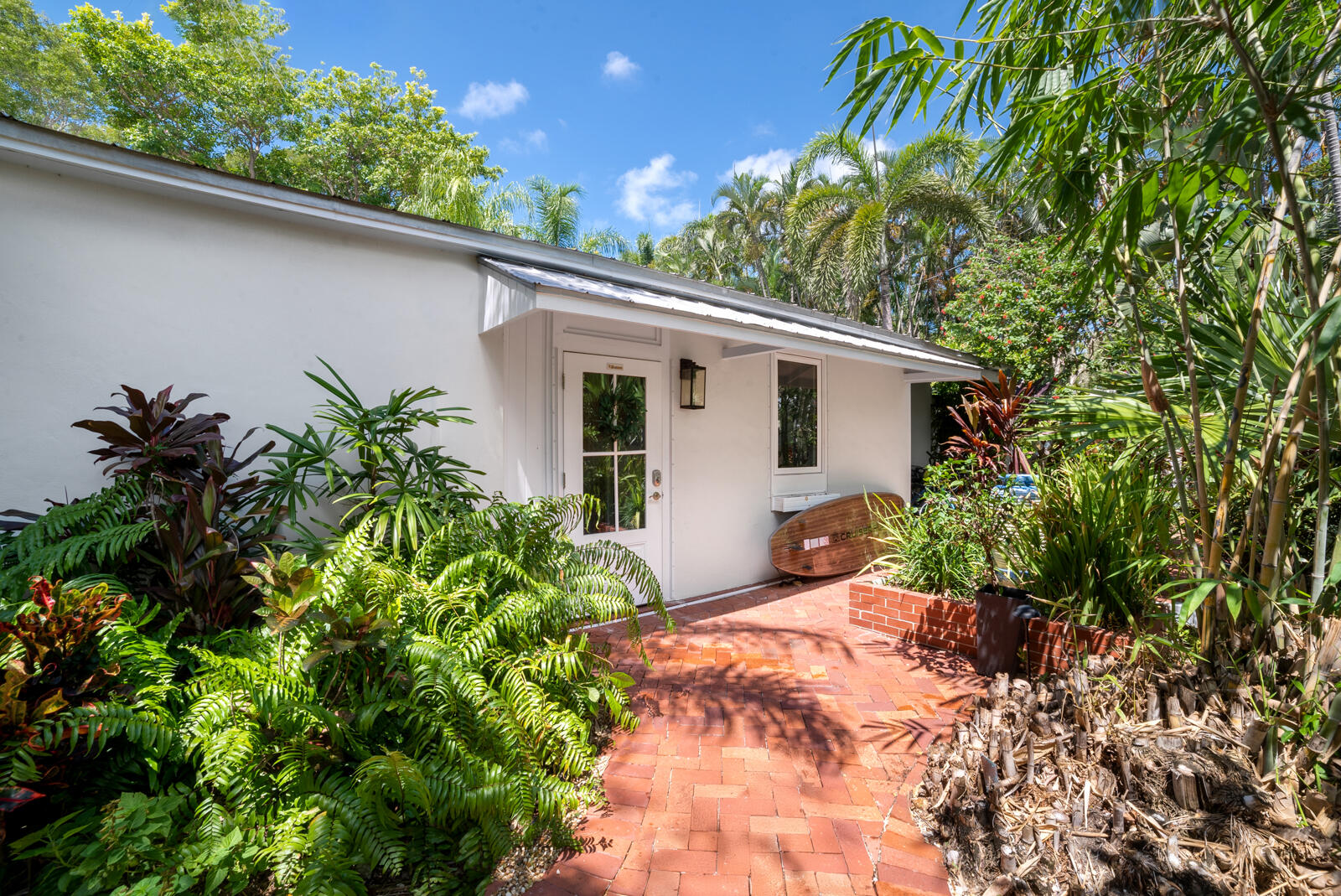 1322 George Street Key West, FL 33040 - Photo 14 of 52 a backyard of a house with potted plants and large tree