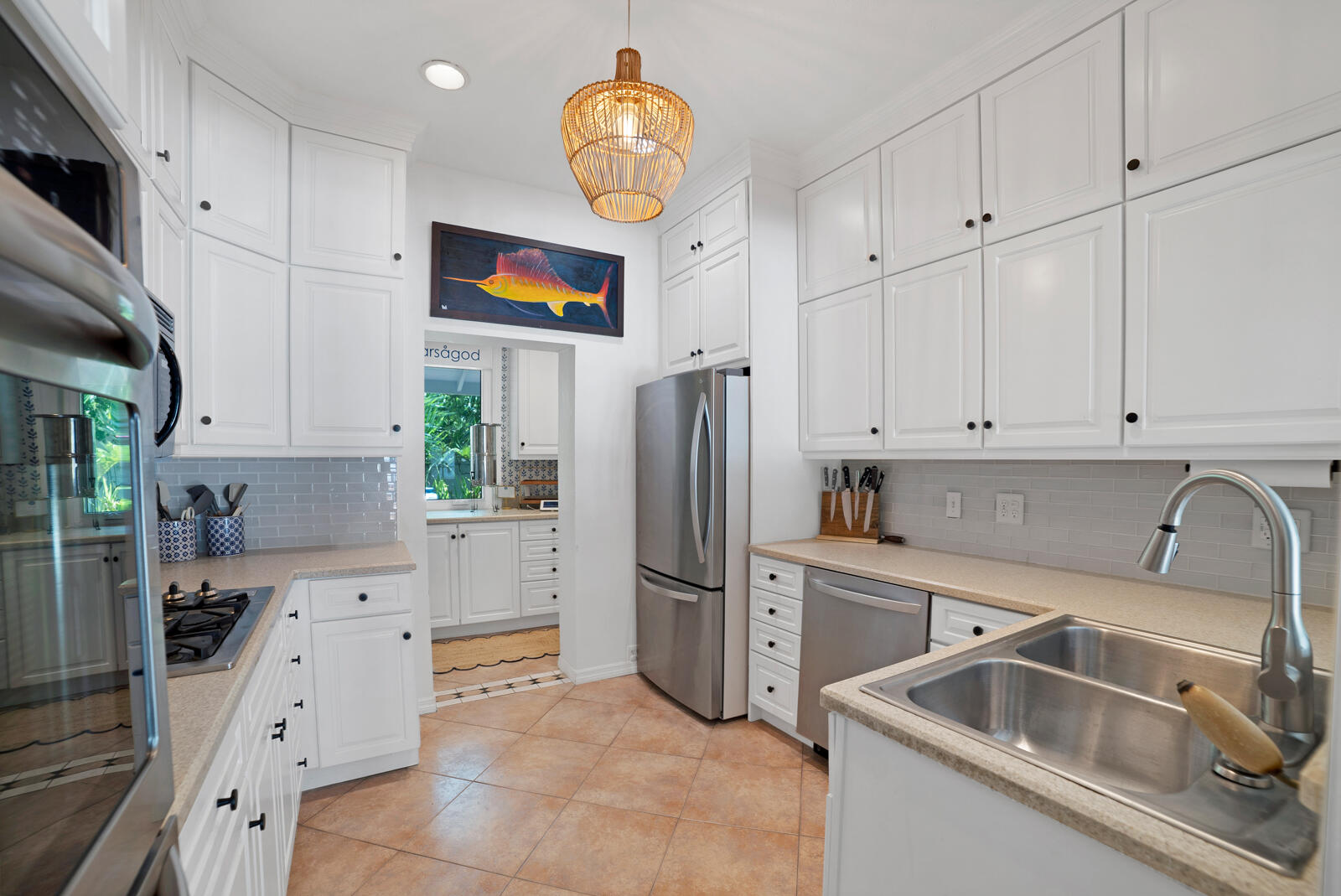 1322 George Street Key West, FL 33040 - Photo 28 of 52 a kitchen that has a sink cabinets counter space and stainless steel appliances