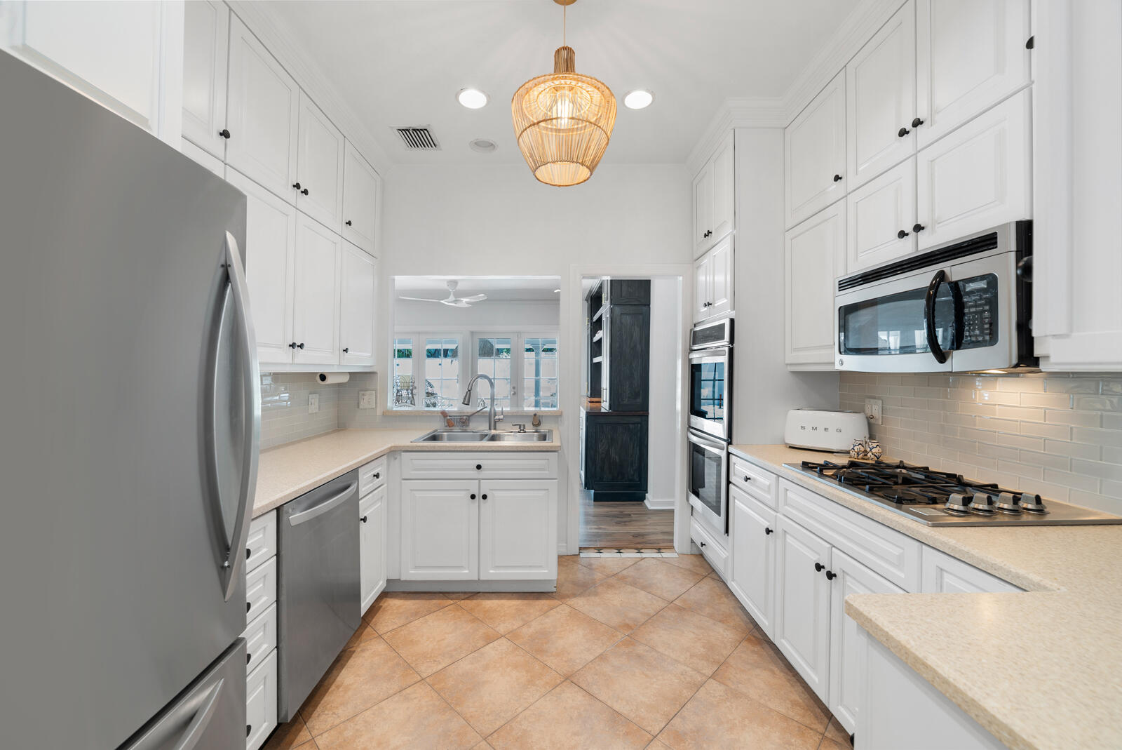 1322 George Street Key West, FL 33040 - Photo 29 of 52 a kitchen with stainless steel appliances a stove a sink and a refrigerator