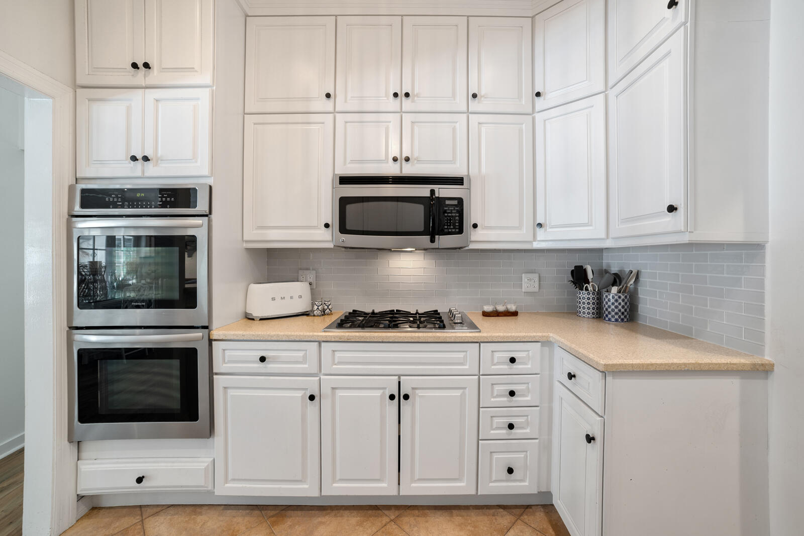 1322 George Street Key West, FL 33040 - Photo 30 of 52 a kitchen with stainless steel appliances granite countertop white cabinets and a stove a oven with white countertops