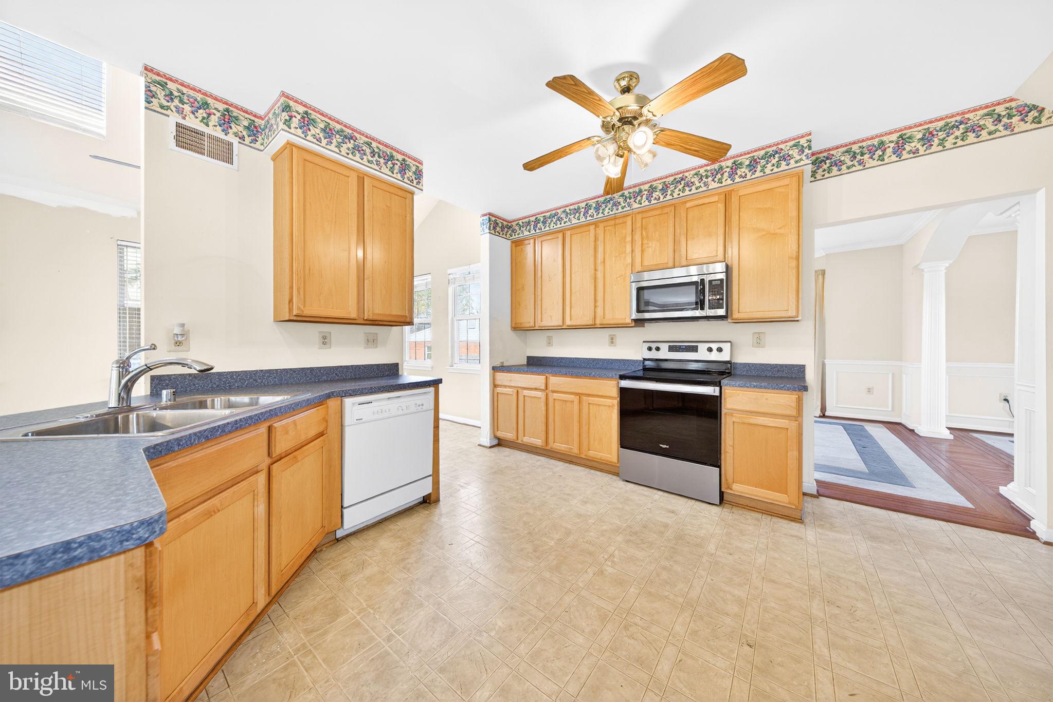 6008 Plata Street Clinton, MD 20735 - Photo 15 of 55 a kitchen with stainless steel appliances a stove a sink and a refrigerator