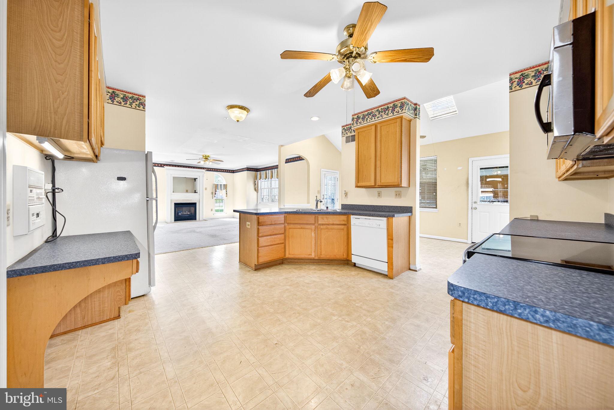 6008 Plata Street Clinton, MD 20735 - Photo 16 of 55 a living room with stainless steel appliances kitchen island granite countertop a stove and a sink