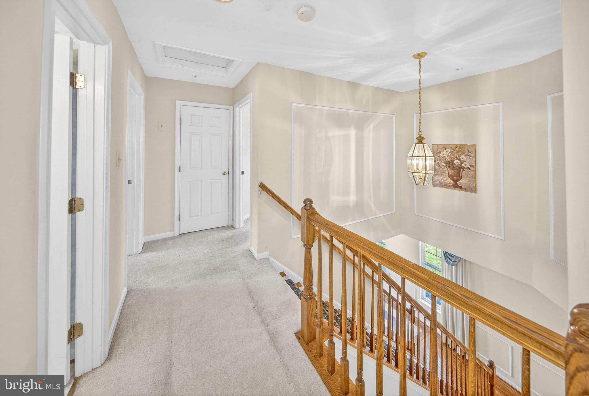 6008 Plata Street Clinton, MD 20735 - Photo 28 of 55 a view of a hallway with wooden floor and staircase