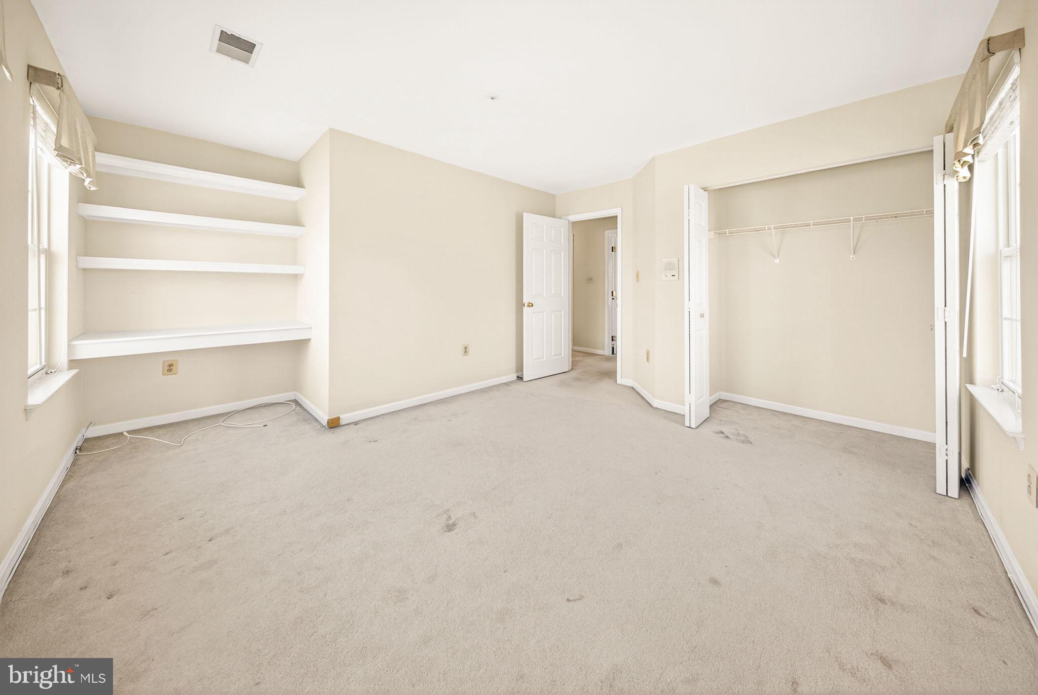 6008 Plata Street Clinton, MD 20735 - Photo 30 of 55 an empty room with a closet and empty racks