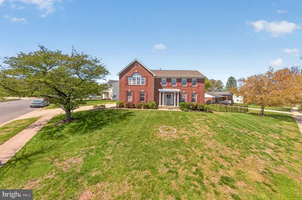 a front view of a house with a big yard