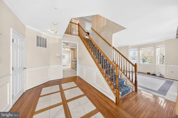 a view of an entryway with wooden floor and a livingroom