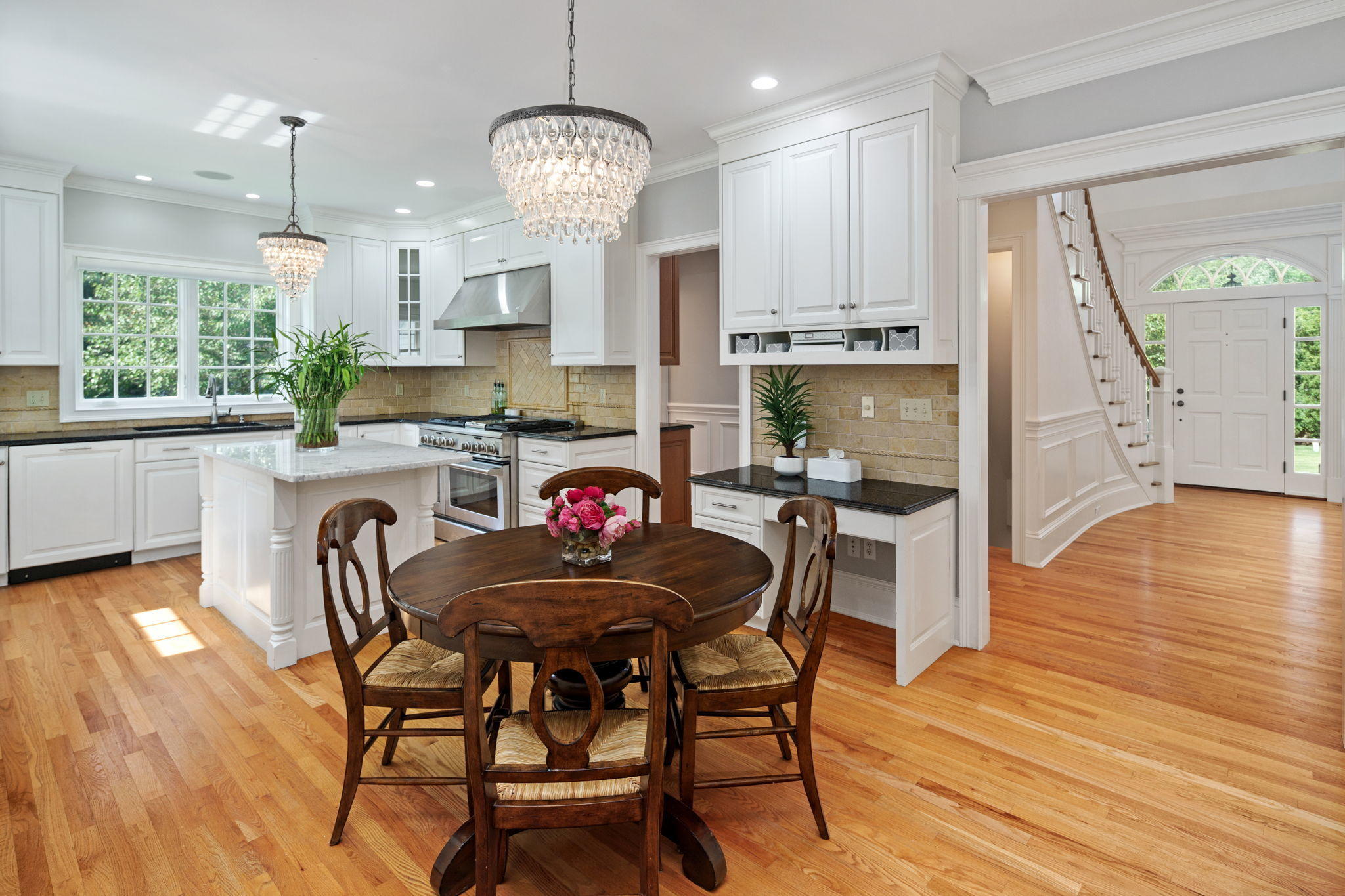 4 Parade Hill Road New Canaan, CT 06840 - Photo 11 of 50 a kitchen with stainless steel appliances granite countertop a table chairs and a refrigerator