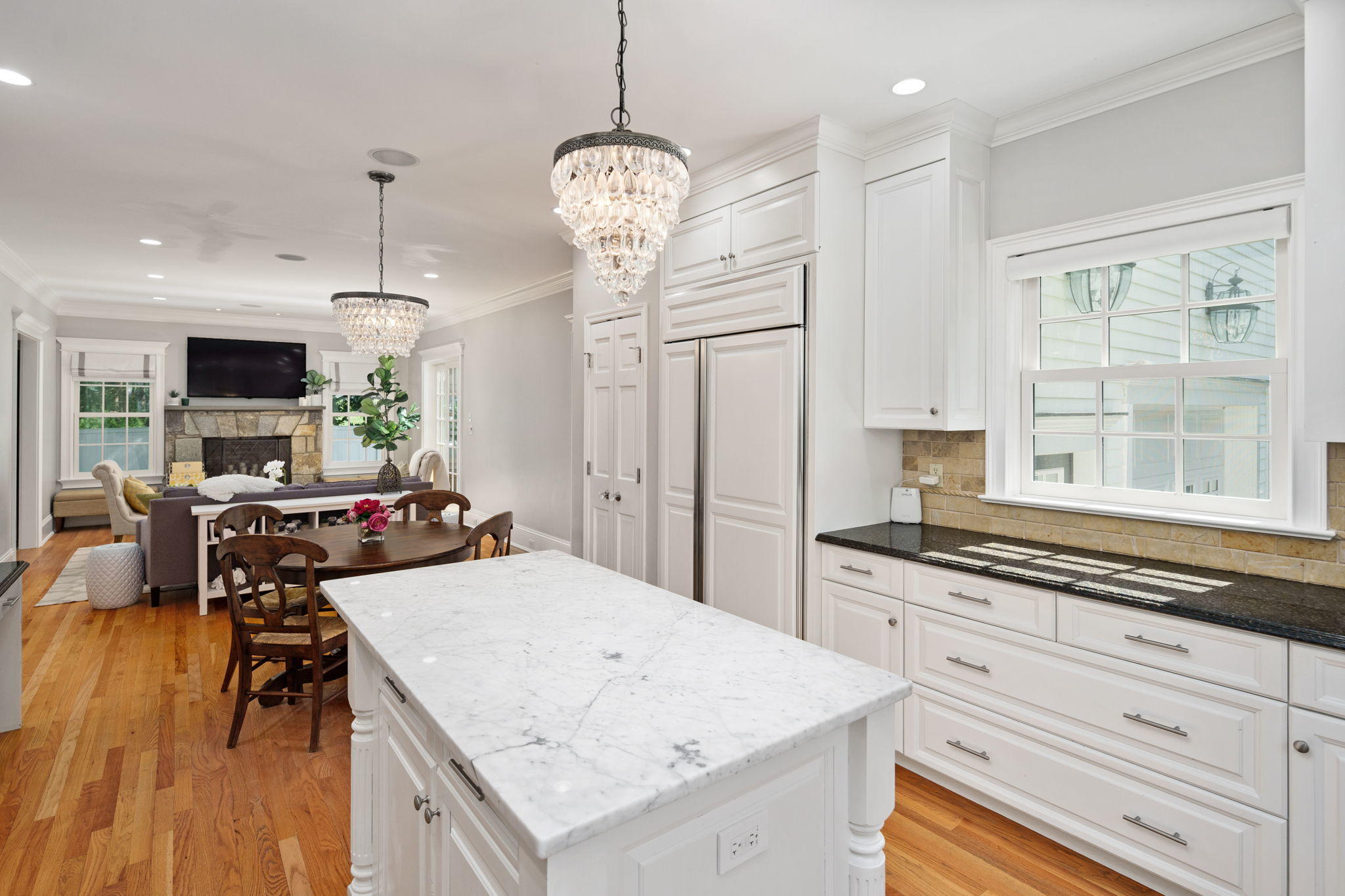 4 Parade Hill Road New Canaan, CT 06840 - Photo 13 of 50 a open kitchen with stainless steel appliances granite countertop a stove top oven a refrigerator a sink dishwasher a dining table and chairs with wooden floor