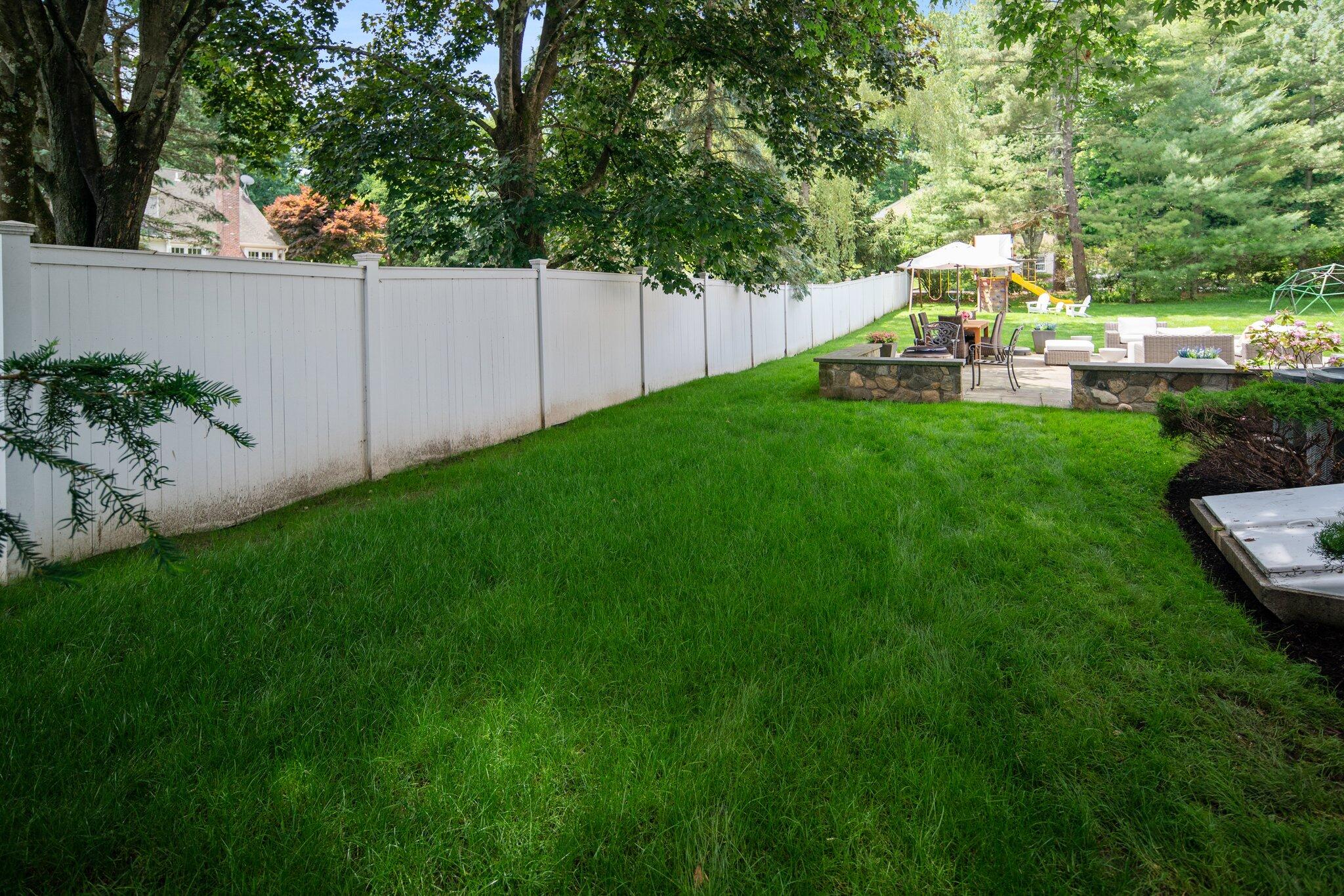 4 Parade Hill Road New Canaan, CT 06840 - Photo 44 of 50 a view of a house with a backyard