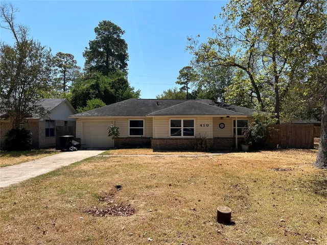 a front view of a house with a yard covered in snow