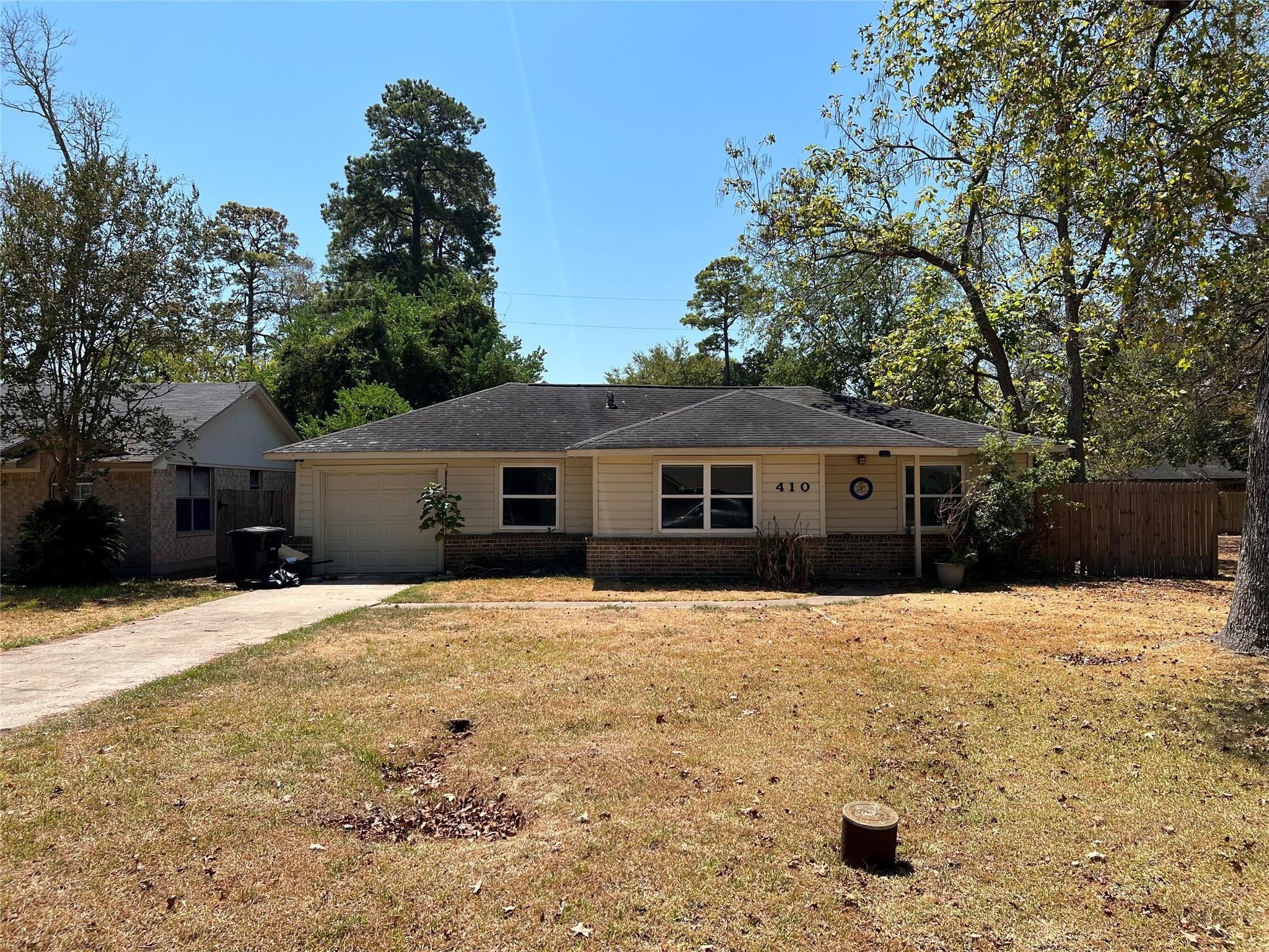 410 Broad Ripple Drive Houston, TX 77336 - Photo 1 of 9 a front view of a house with a yard covered in snow