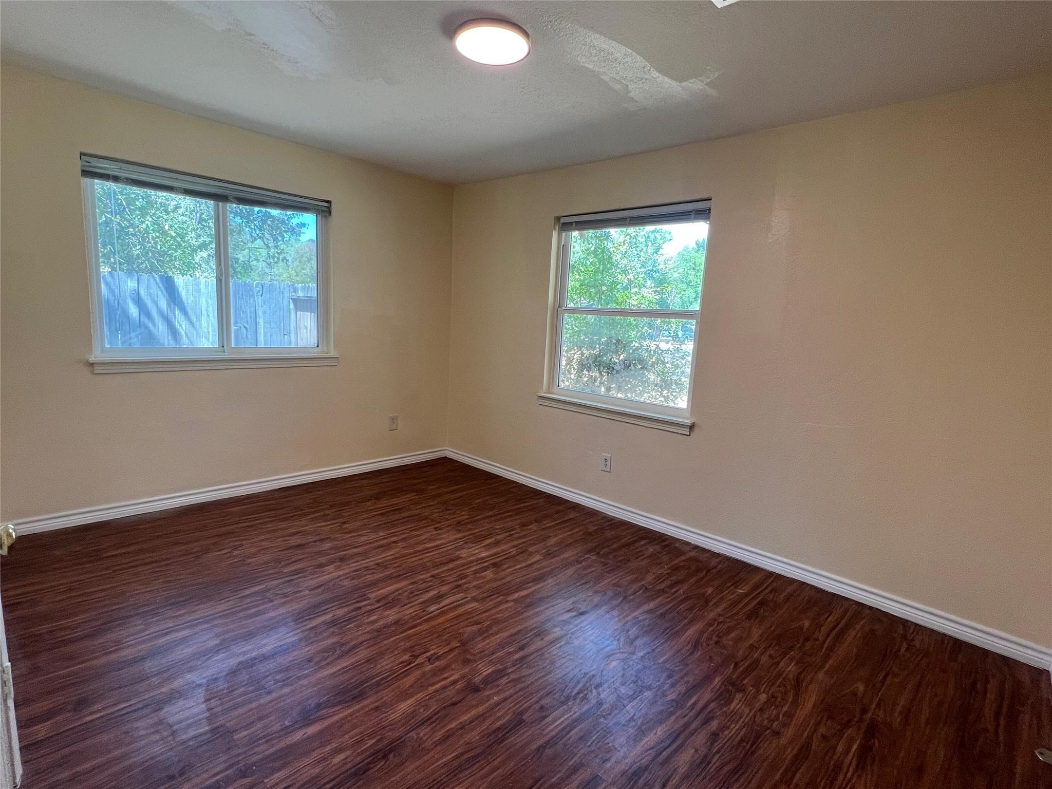 410 Broad Ripple Drive Houston, TX 77336 - Photo 5 of 9 a view of an empty room with wooden floor and a window
