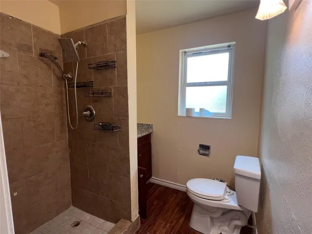 a bathroom with a toilet and a shower
