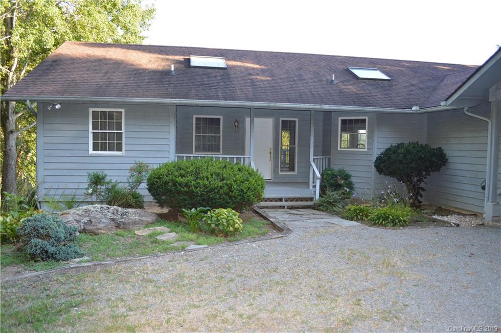 424 Goldfinch Lane Clyde, NC 28721 - Photo 30 of 42 a front view of a house with garden and plants