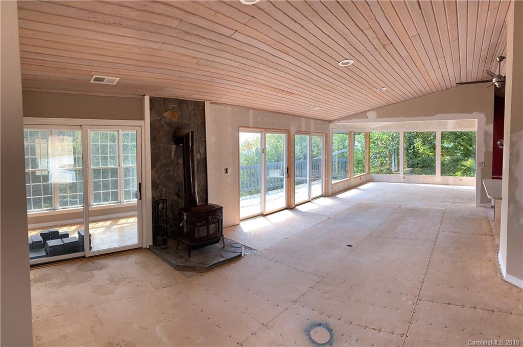 424 Goldfinch Lane Clyde, NC 28721 - Photo 36 of 42 a living room with furniture and large windows