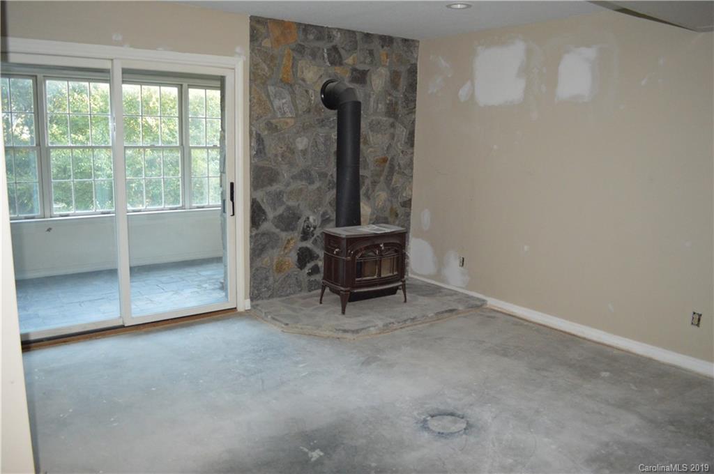 424 Goldfinch Lane Clyde, NC 28721 - Photo 10 of 42 an empty room with a chair and windows