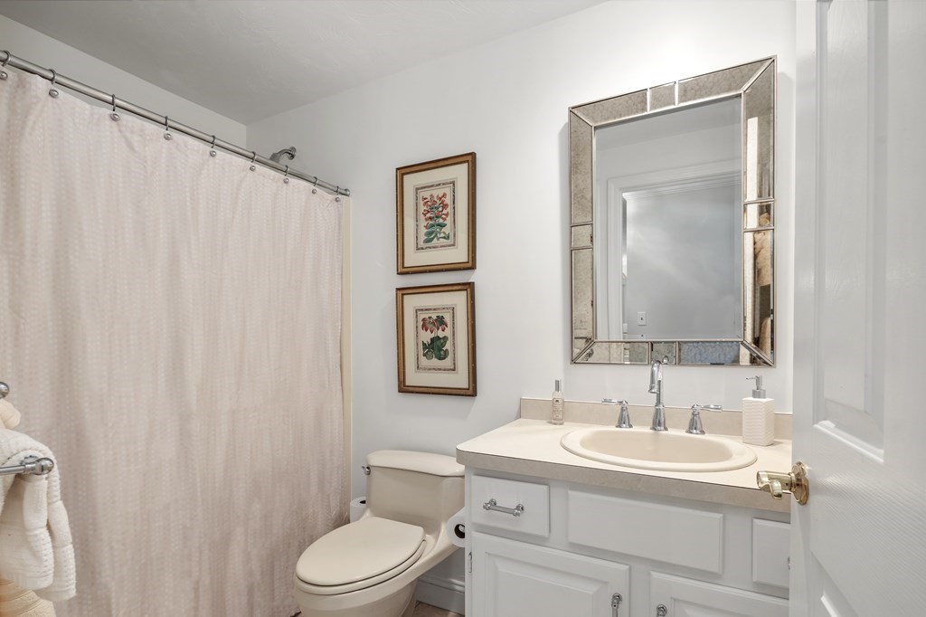 70 Tussock Brook Road, Unit 70 Duxbury, MA 02332 - Photo 11 of 20 a bathroom with a toilet a sink and a mirror