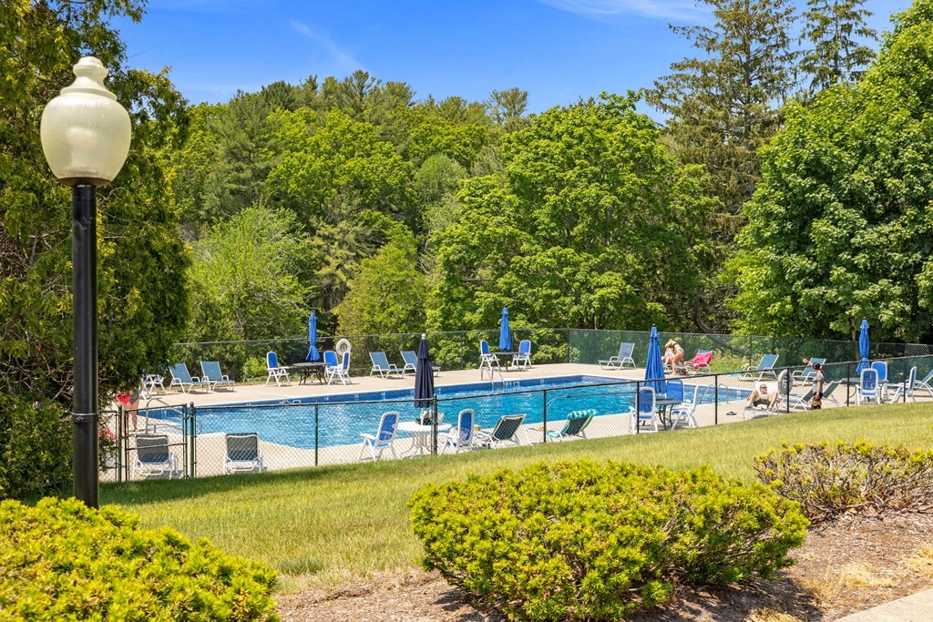 70 Tussock Brook Road, Unit 70 Duxbury, MA 02332 - Photo 17 of 20 a view of a swimming pool with a patio and a garden