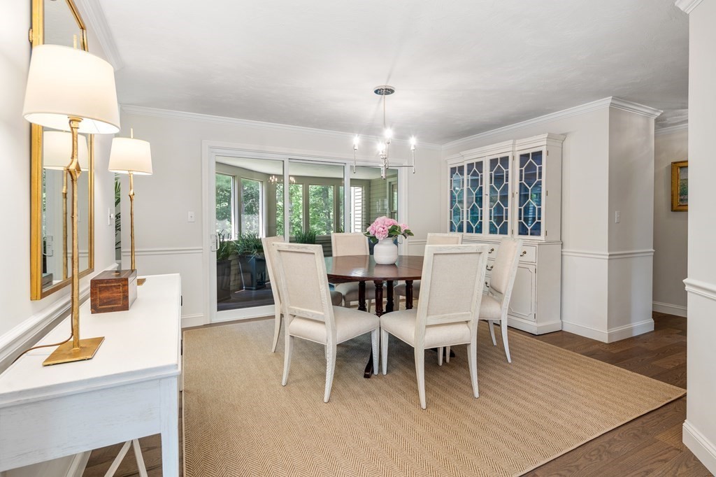 70 Tussock Brook Road, Unit 70 Duxbury, MA 02332 - Photo 5 of 20 a dining room with furniture a chandelier and wooden floor
