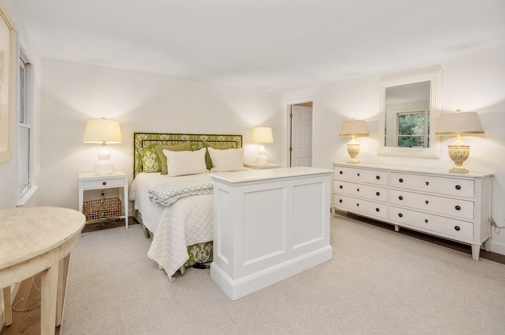 70 Tussock Brook Road, Unit 70 Duxbury, MA 02332 - Photo 8 of 20 a bed room with a bed and a chair