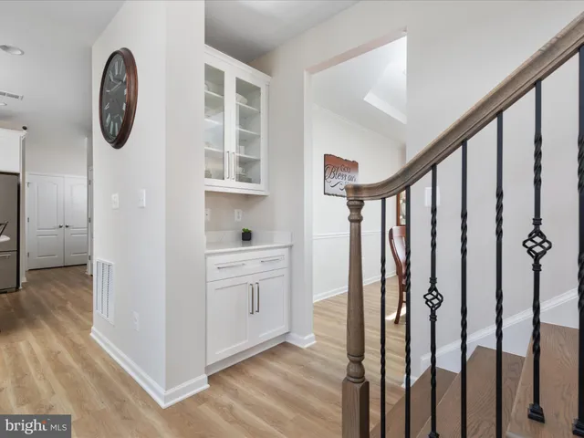 a kitchen with a sink white cabinets and stainless steel appliances