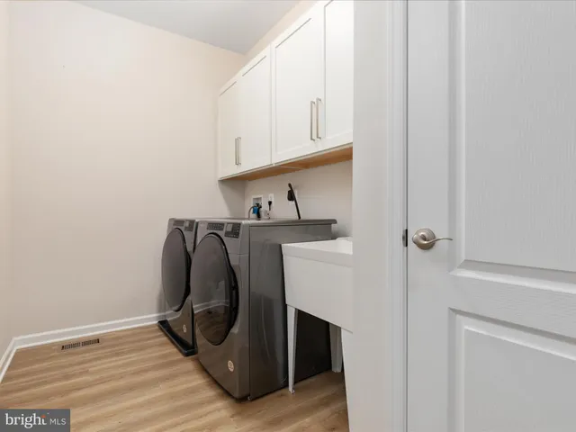 a view of walk in closet with clothes