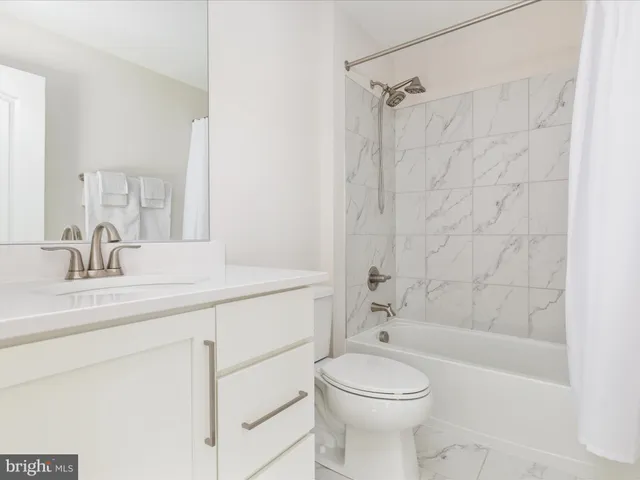 a bathroom with a sink vanity tub and mirror