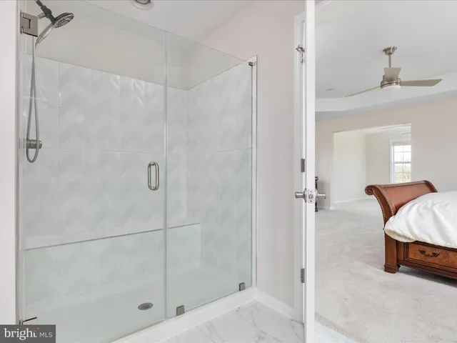 a bedroom with a bed and a wooden floor