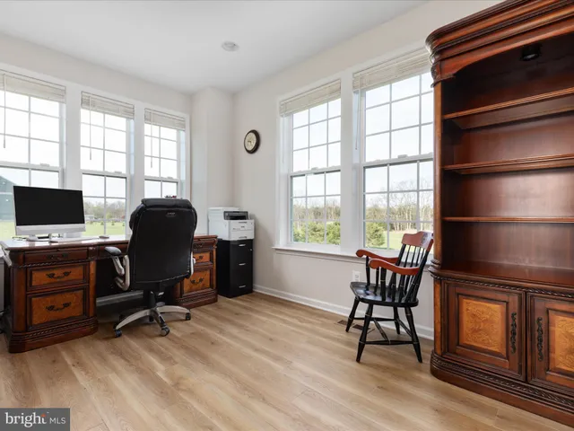 a view of a workspace with furniture and a window