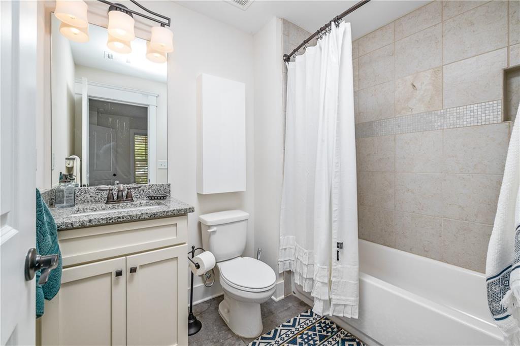 1333 Oakview Road Decatur, GA 30030 - Photo 20 of 28 a bathroom with a granite countertop toilet a sink and a bathtub