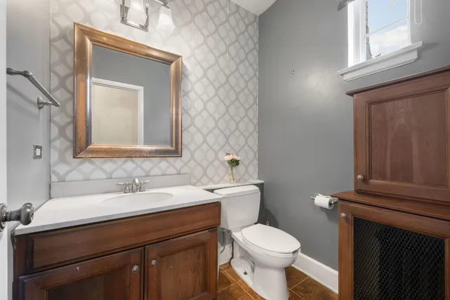 a bathroom with a toilet sink and mirror