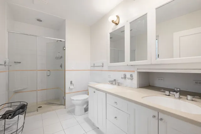 a bathroom with a sink and mirror with toilet