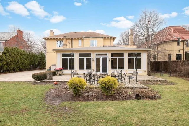 a view of a house with a yard and sitting area