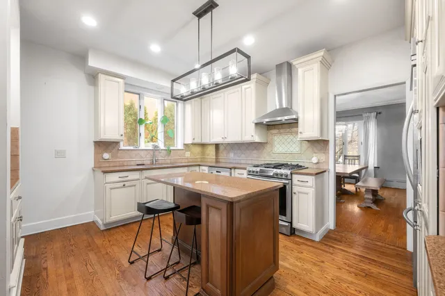 a kitchen with stainless steel appliances granite countertop a stove and a refrigerator