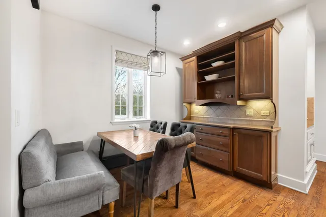 a kitchen with a table chairs sink and cabinets