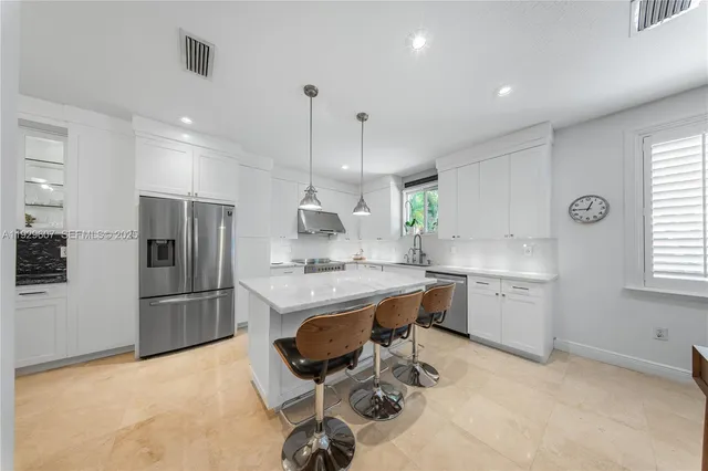 a kitchen with a sink stainless steel appliances and cabinets