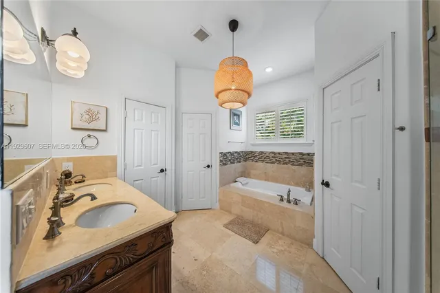 a bathroom with a sink a bathtub and a shower