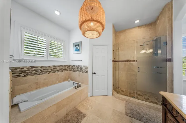 a bathroom with a bathtub and a shower