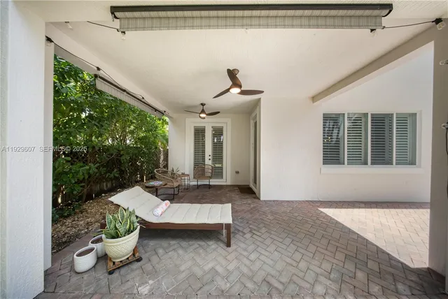 a view of a patio with a chairs and a potted plant