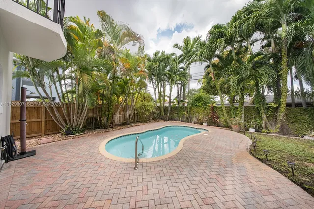 a view of swimming pool with a patio and a yard