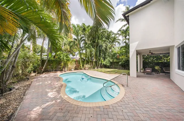 a view of a swimming pool with lounge chair