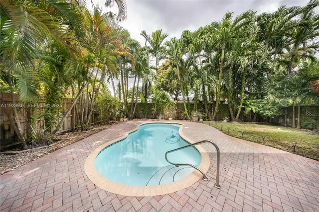 a backyard of a house with yard and outdoor seating