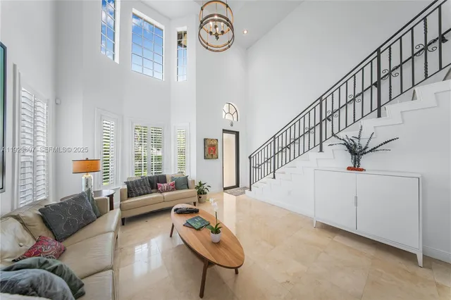 a living room with furniture and a chandelier